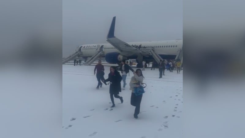 Video from the incident show passengers running from the plane through the snow-covered tarmac...