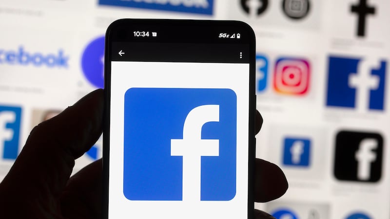 FILE - The Facebook logo is seen on a cell phone in Boston, USA, Oct. 14, 2022.
