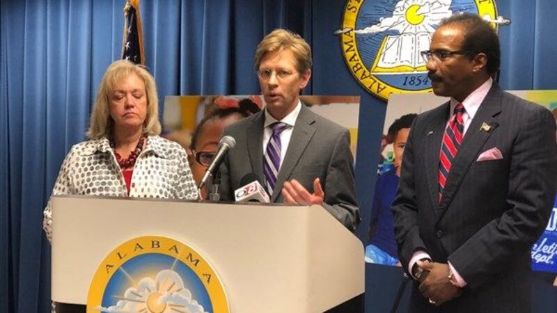 State Superintendent Dr. Eric Mackey (center) announces the two sides are close to reaching a...