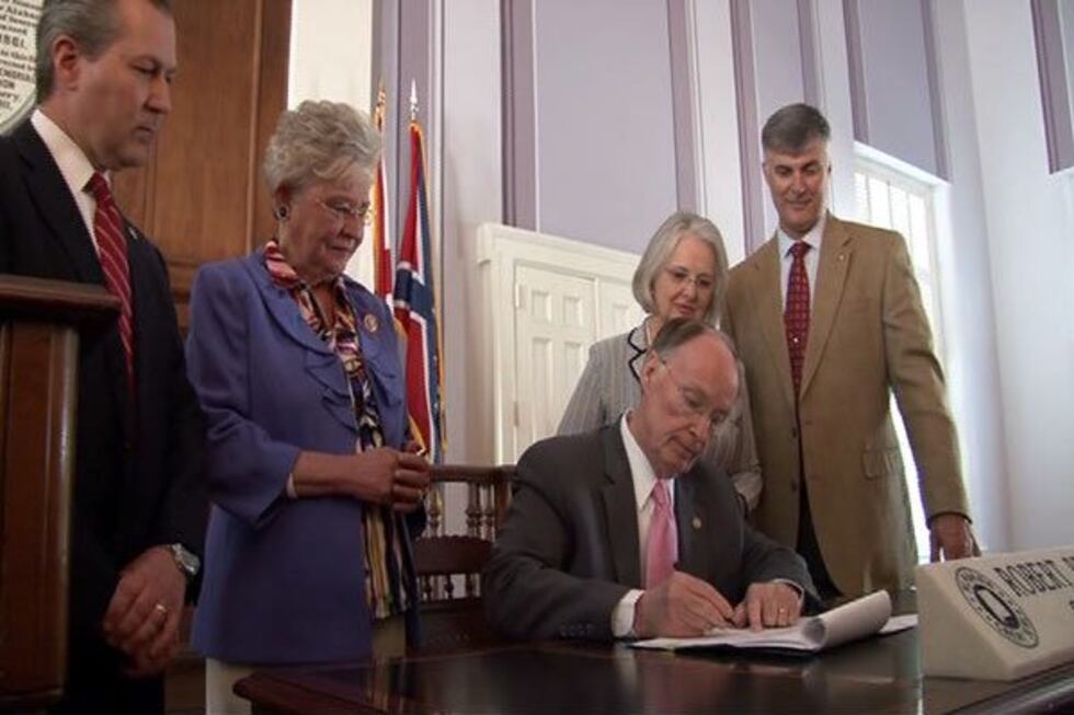 Gov. Bentley signs the Women's Health and Safety Act into law as House Speaker Mike Hubbard...