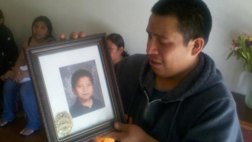 Marilieo Garcia breaks down in tears as he looks at a picture of his oldest son, Victor.