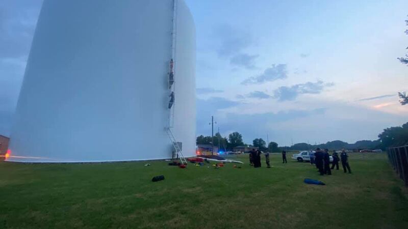 Firefighters climbed the tank to convince the woman swimming inside to come to them. They were...