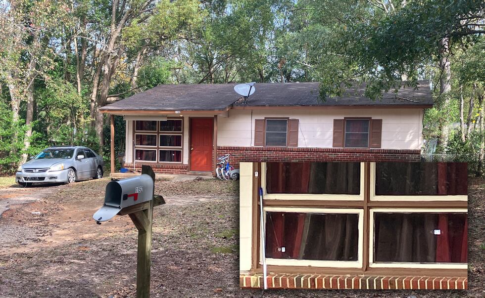 Bullet holes can be seen in front window panes of this Rhett Drive home in Mobile, where...