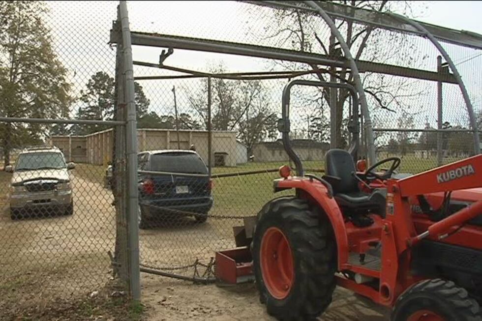 A tractor blocks this crumpled gate after three teens drove a car through it attempting to...