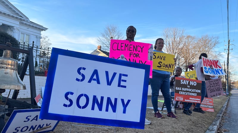 People gather outside the Alabama Governor's Mansion in Montgomery, Ala., on Feb. 16, 2026, to...