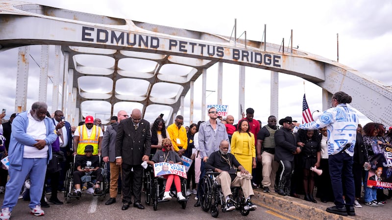 People march over the Edmund Pettus Bridge on the 61st Bloody Sunday Anniversary, Sunday,...
