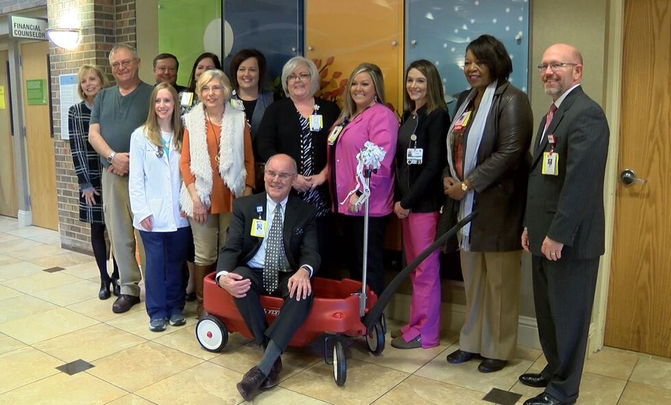 Leggett, hospital officials and employees stand with the new wagons (Source: WSFA 12 News)