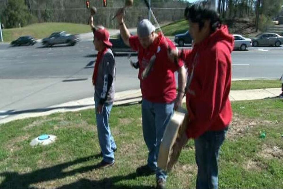 Oklahoma Indian tribe protestors shake their ceremonial rattles and beat a drum at the site of...